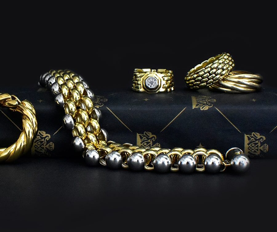 Yellow and white gold jewellery collection including hoop earrings, beaded bracelets, and designer rings from Mark Solomon Jewellers, Cape Town.