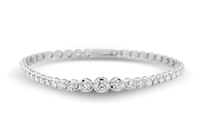 a Unique White Gold Diamond Bracelet Featuring a Central Line of Three Larger Diamonds Flanked by Smaller Diamonds.