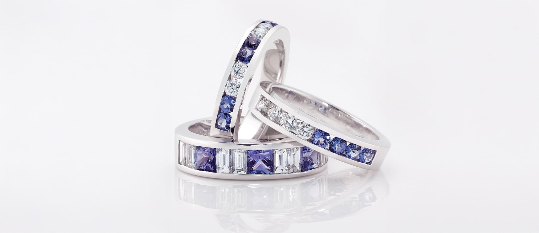 Platinum Rings Featuring Blue Tanzanite and White Diamonds in Mixed Cuts
