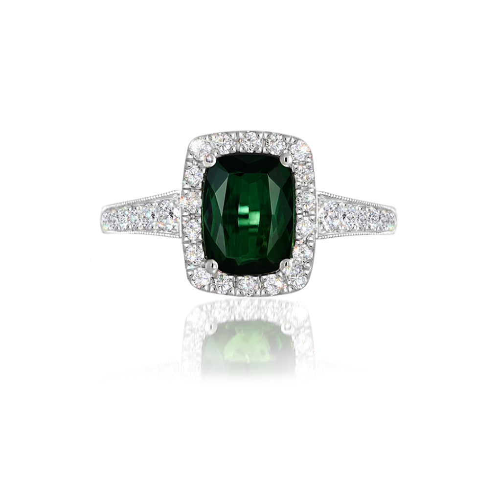 Green Gemstone Jewellery | This enchanting Green Tourmaline Diamond Halo Ring heralds a deep, verdant green tourmaline (chrome tourmaline totalling 1.471ct with EGL Certification), surrounded by a glittering halo of micro-set small round brilliant cut white diamonds, with diamonds extending down the sides of the band (30 diamonds totalling: 0.34ct, G-H colour VS-SI clarity).

Handcrafted by our Master Goldsmiths on our premises using the highest grade 14ct white gold.