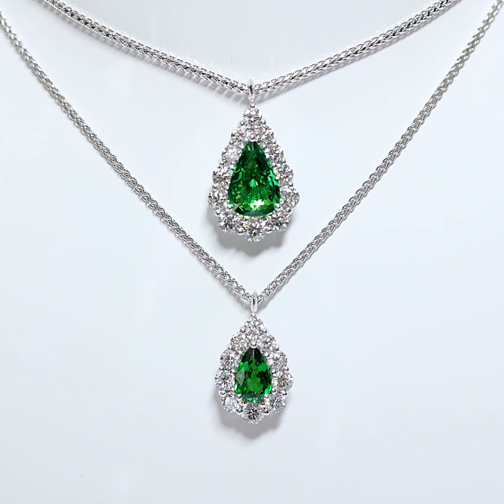 Green gemstone jewellery | This Pear Shape Tsavorite and Diamond Halo Necklace features a pear shape tsavorite (tsavorite totalling: 2.026ct, Certified), accentuated by a halo of sparkling white diamonds (12 diamonds totalling: 1.32ct, D-F Colour, VS Clarity).

Handcrafted by our Master Goldsmiths on our premises using the highest grade 18ct white gold, this future heirloom piece will turn every head in the room with its exquisite, sparkle, colour and lustre.