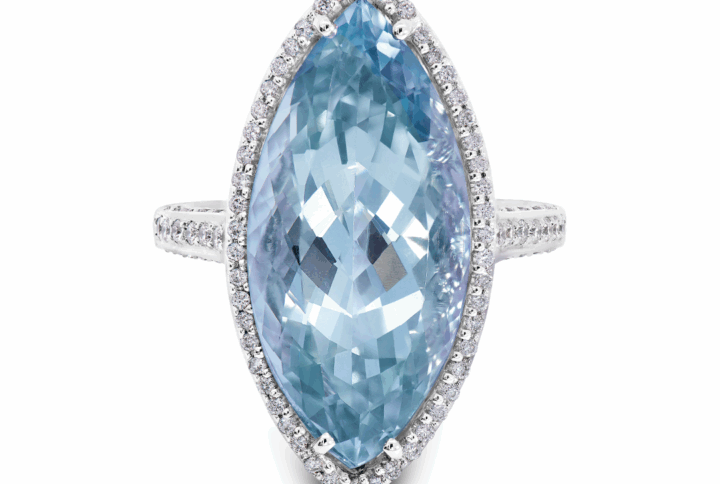 White Gold Ring with a Large Marquise-cut Blue Topaz Center Stone, Surrounded by a Diamond Halo, with Diamonds Continuing Down the Band.