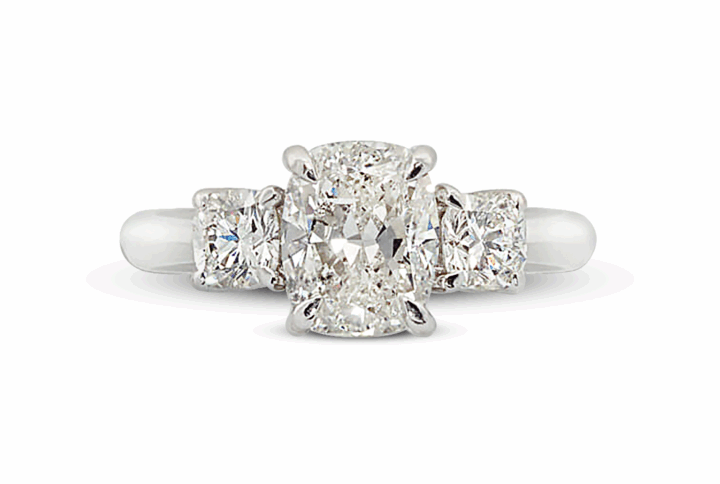 Platinum or White Gold Three-stone Ring with a Rectangular Cushion-cut and Two Cushion-cut Diamonds.