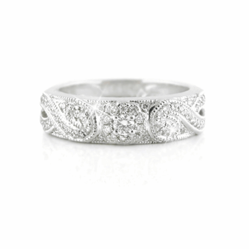 Wide white gold or platinum diamond band with intricate swirling pavé-set diamond patterns and a central diamond cluster.
