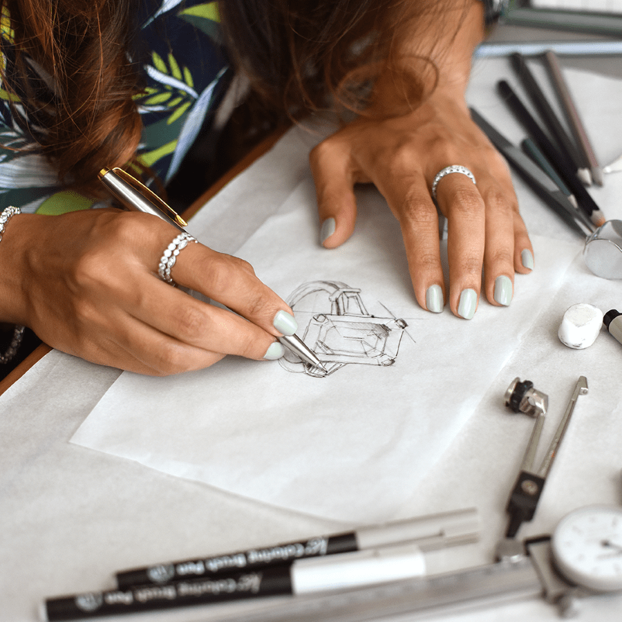 Jewellery Designer Sketching a Bespoke Emerald-cut Diamond Ring with Professional Draughting Tools at Mark Solomon Jewellery Designers.