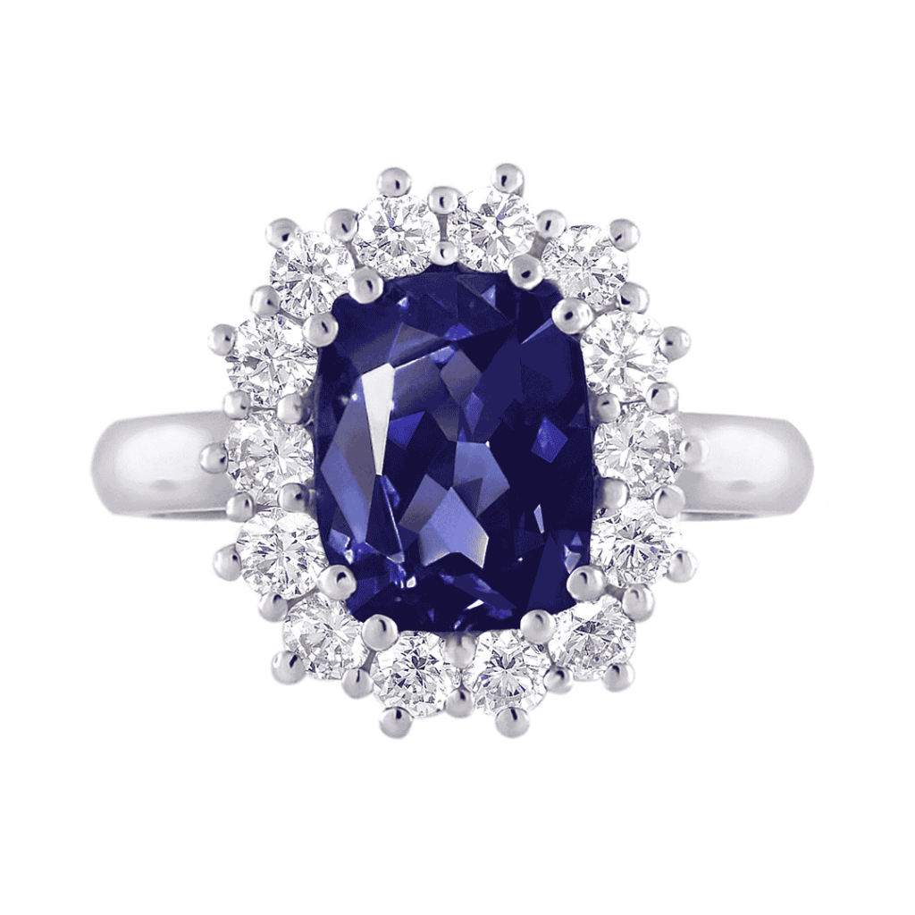 Cushion Cut Tanzanite and Floral Diamond Halo Ring - Mark Solomon Jewellers a Stunning Ring Featuring a Large Oval-cut Deep Purple-blue Tanzanite As the Center Stone, Surrounded by a Unique Floral or Sunburst-shaped Halo of Round White Diamonds, Set on a Polished White Gold or Platinum Band.