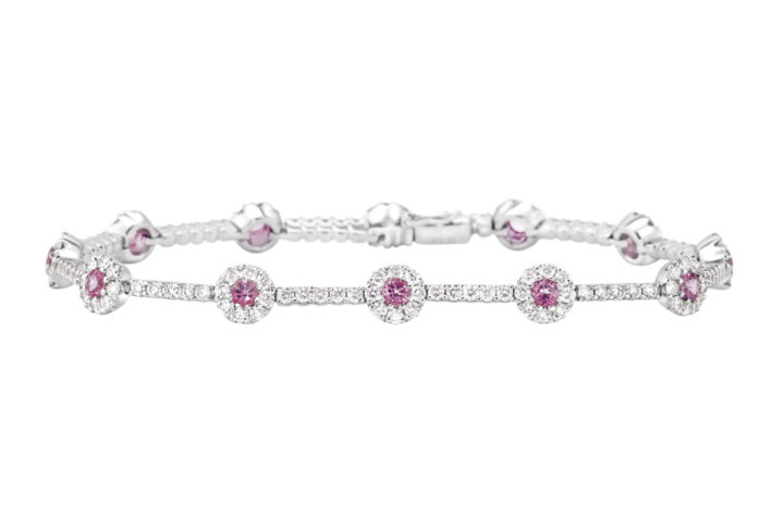a White Gold Bracelet with Pink Sapphire and Diamond Halo Clusters.