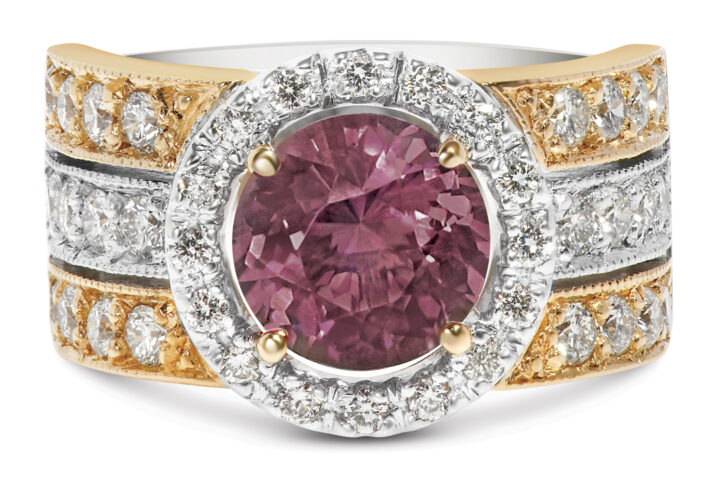 a Magnificent Three-band Two-tone Ring Featuring a Large Round-cut Rhodolite Center Stone Encircled by a Diamond Halo, with Outer Yellow Gold Bands and a Central White Gold Band, All Adorned with Diamonds and Milgrain Detailing.